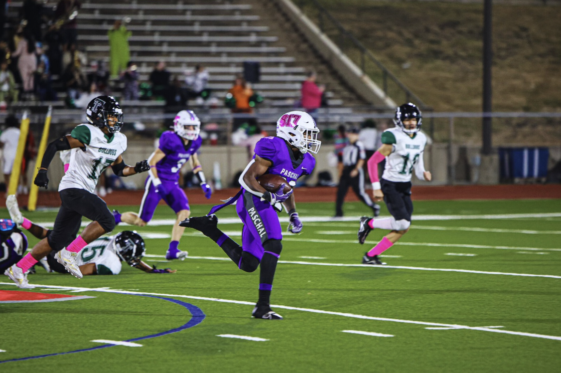 Marquez Dean (12) makes a break for the end zone at the Trimble Tech game on October 31st. During this game, he rushed for 119 yards and made two touchdowns. 